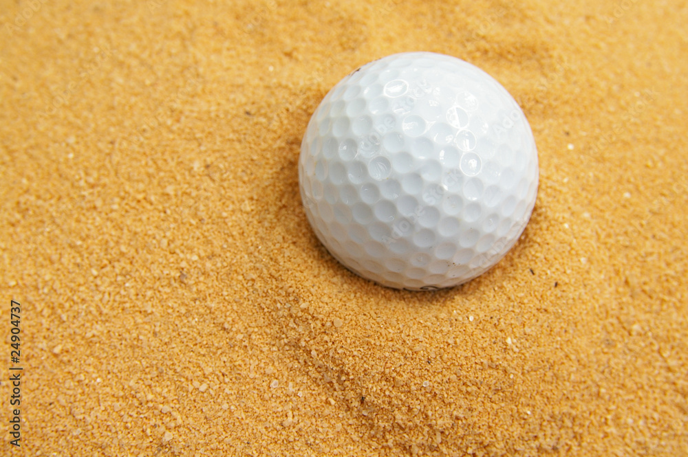 closeup of a golf ball in a sand trap closeup of a golf ball in a sand trap