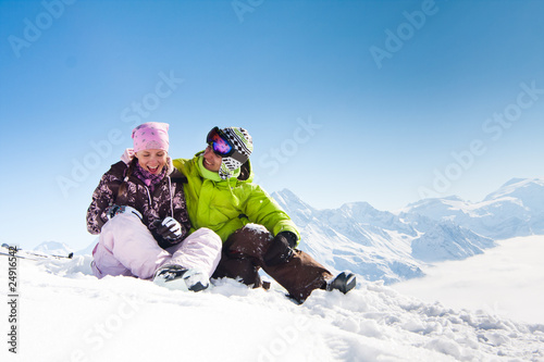 Young happy couple in winter mountains photo