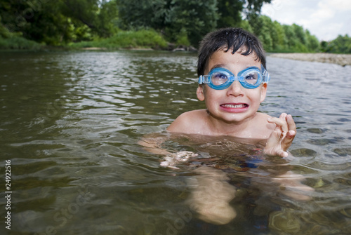 Boy in goggles in creek