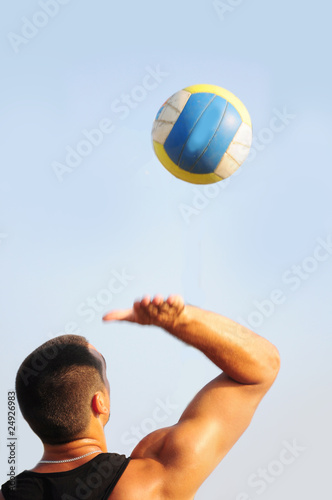 Young man playing beach volleyball © Baronb
