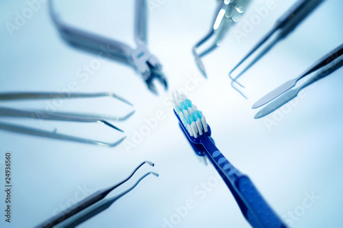 Toothbrush surrounded by dental instruments , very shallow dof