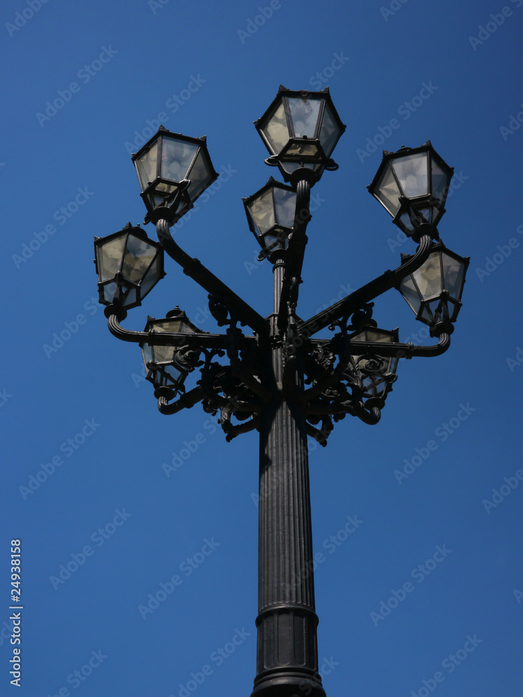 an old street lantern with blue sky