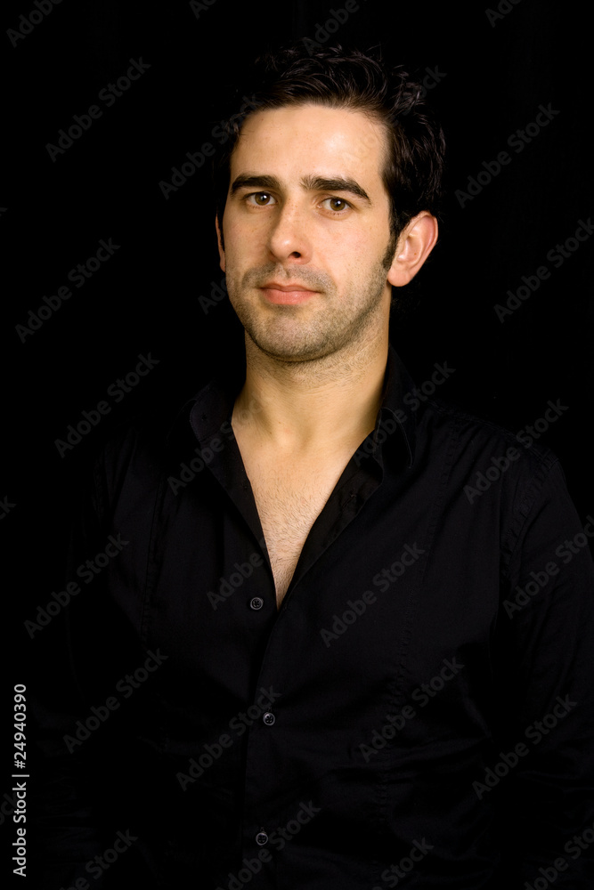 Portrait of young attractive man on a black background