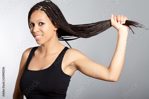 Lovely afro american woman with long hair over grey