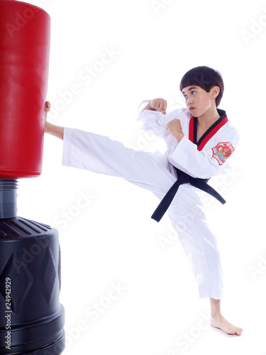 child kicking punching bag isolated on white background