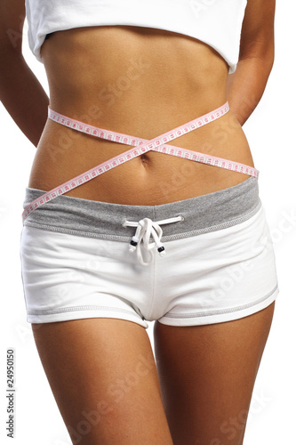 woman measure her waist belly close-up by metre-stick