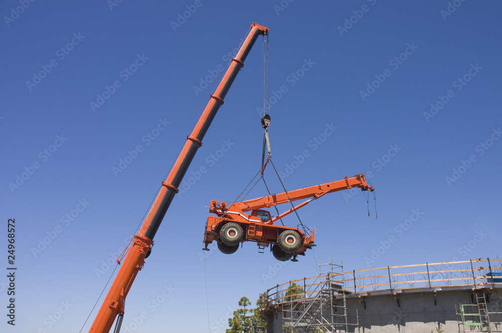 Fototapeta premium Very large crane lifting small crane