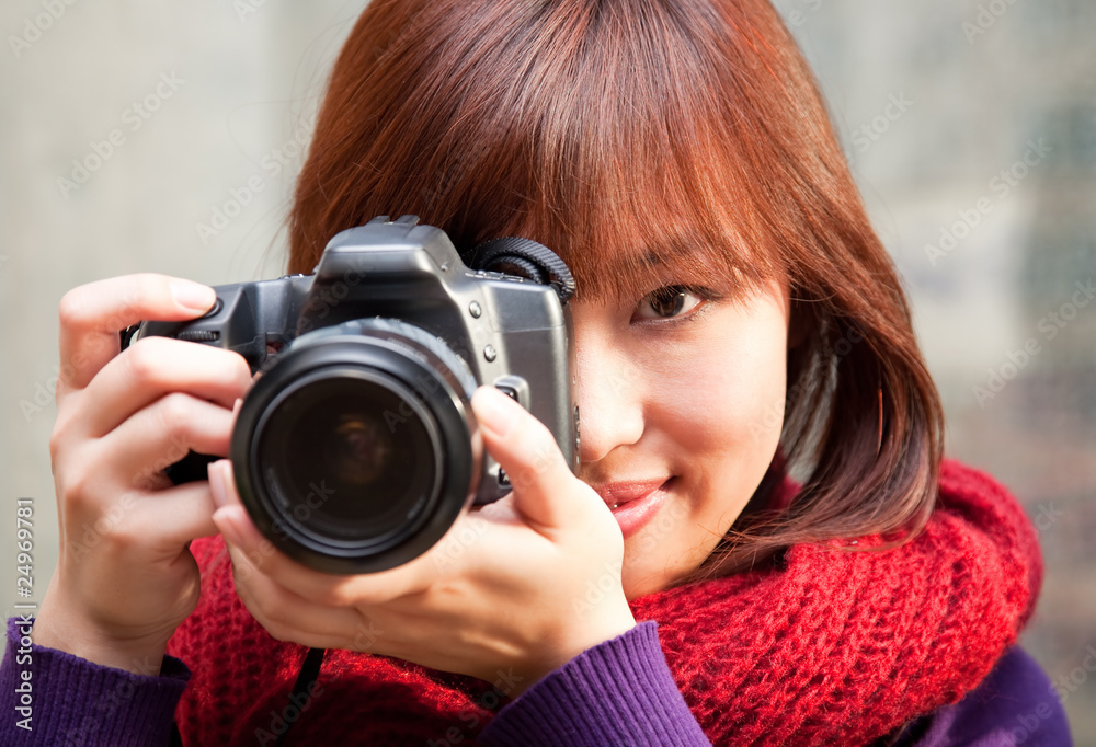 Female photographer using SLR camera. Female photographer using SLR camera.