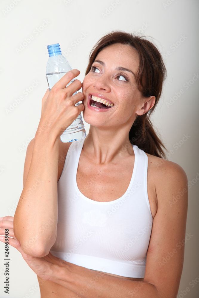 Closeup of woman drinking water after exercising Closeup of woman drinking water after exercising
