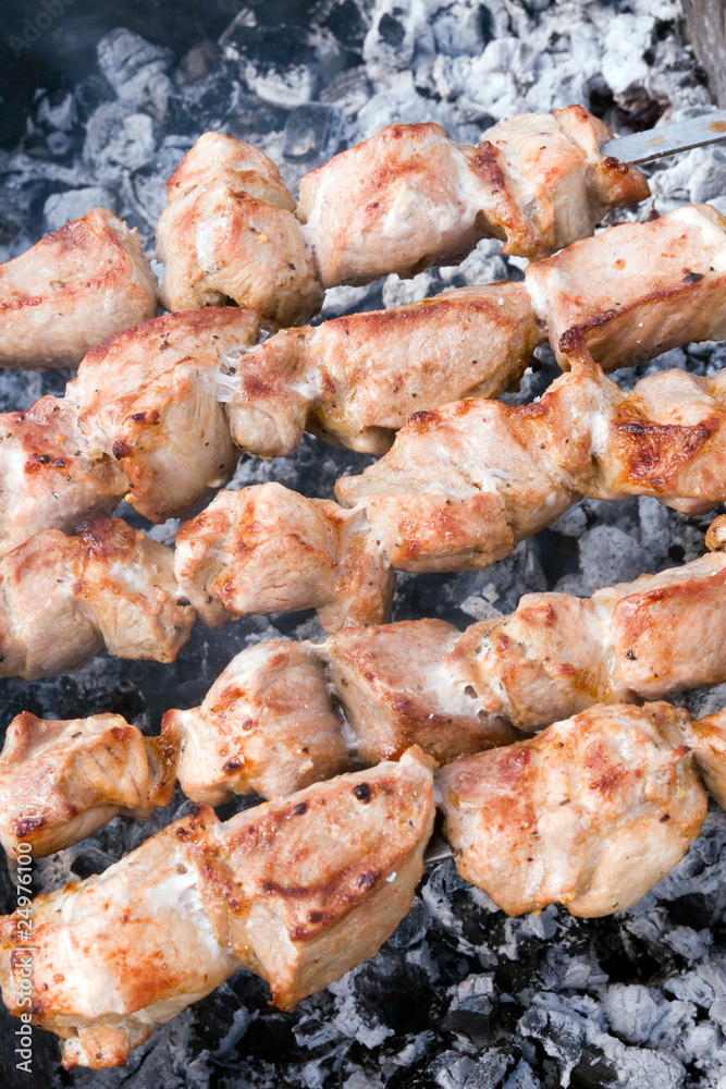 Closeup of meat cooking on a skewer