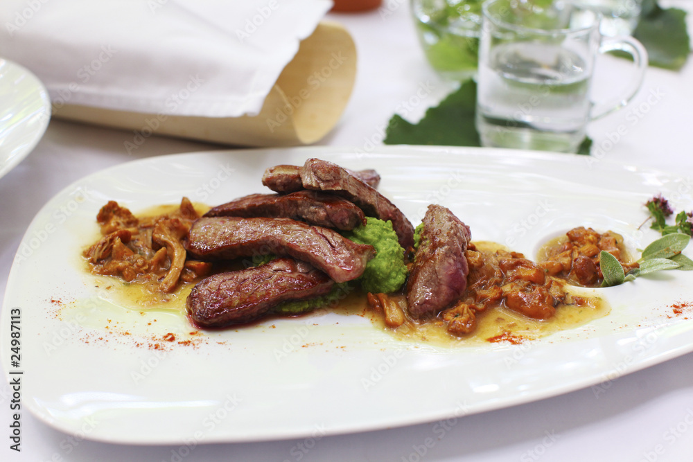 Beef fillet tagliata with wild mushrooms on the side