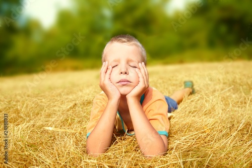 Young boy laying on ground