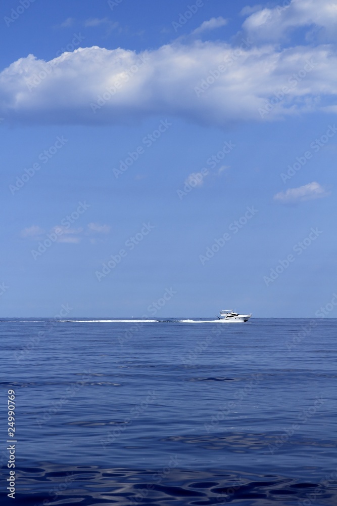 motorboat fisherboat cruising speed on blue sea