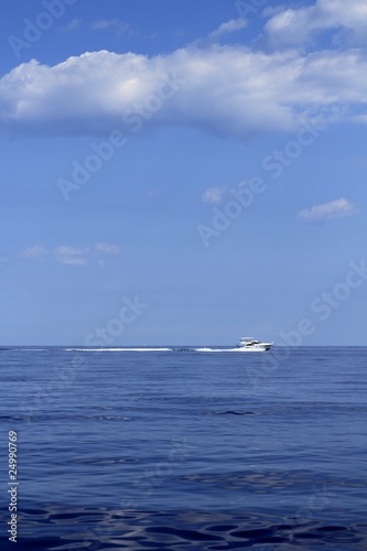 Fototapeta Naklejka Na Ścianę i Meble -  motorboat fisherboat cruising speed on blue sea
