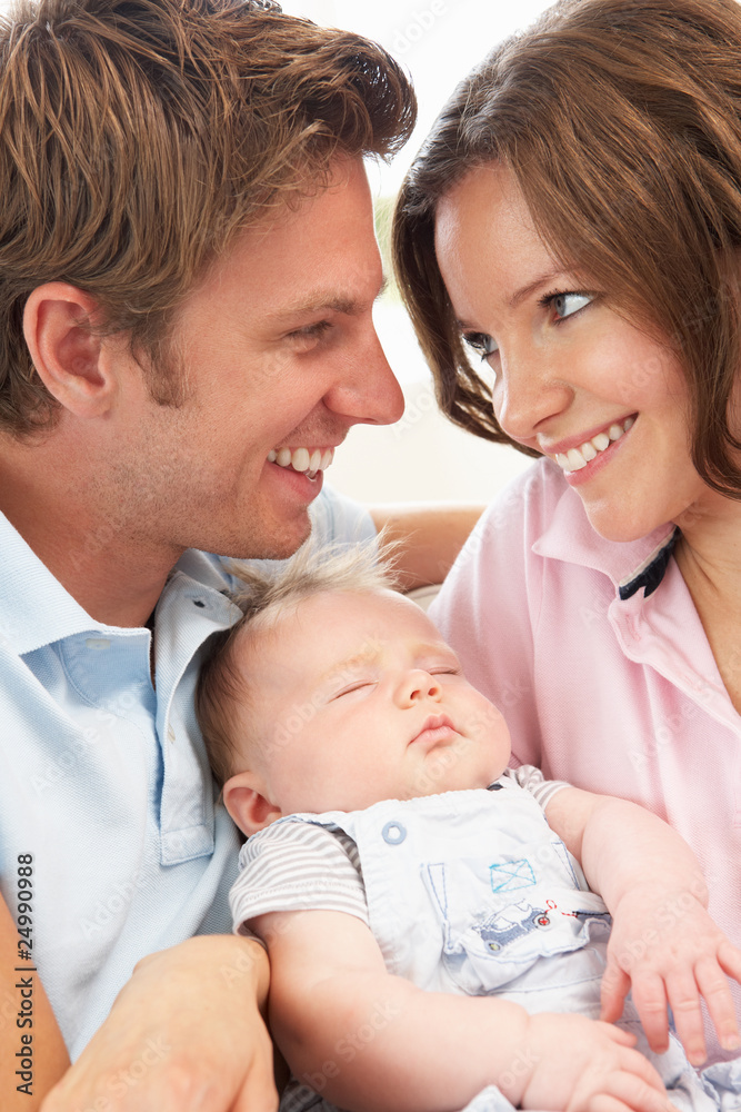 Close Up Of Parents Cuddling Newborn Baby Boy At Home Close Up Of Parents Cuddling Newborn Baby Boy At Home