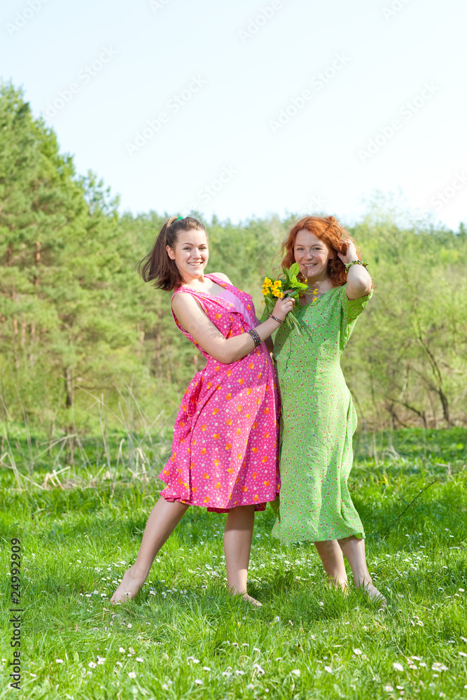 Fototapeta premium funny mother and daughter on green grass