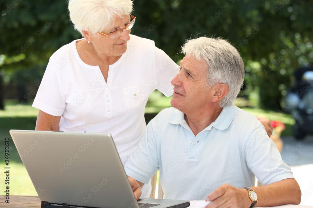 Senior couple using laptop computer at home Senior couple using laptop computer at home