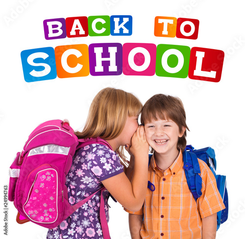 portrait of a blonde girl whispering in boy's ear photo