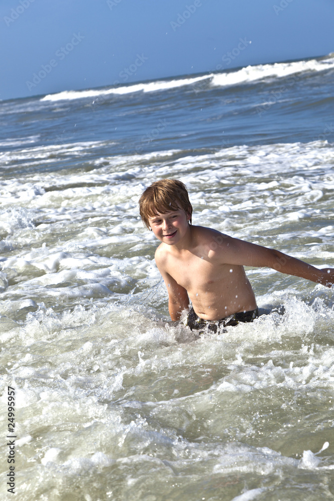 Fototapeta premium child has fun in the waves