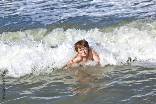 child has fun in the waves © travelview