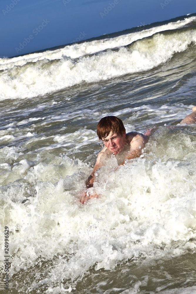 Fototapeta premium child has fun in the waves