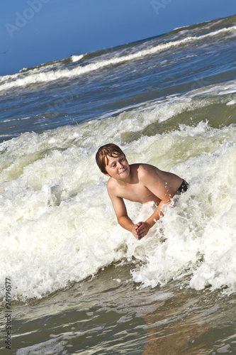 child has fun in the waves