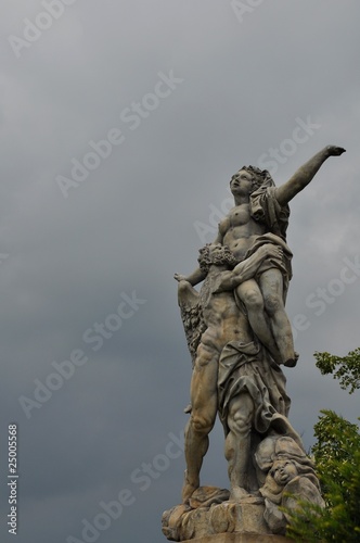 Statue at dramatic sky