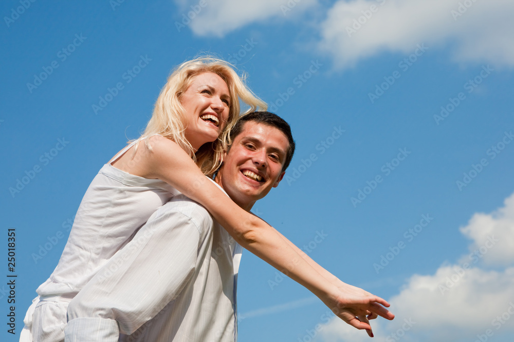 Young couple walking through summer lawn Young couple walking through summer lawn
