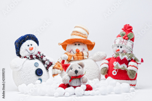 Christmas Teddy with three Snowmen on a white background.