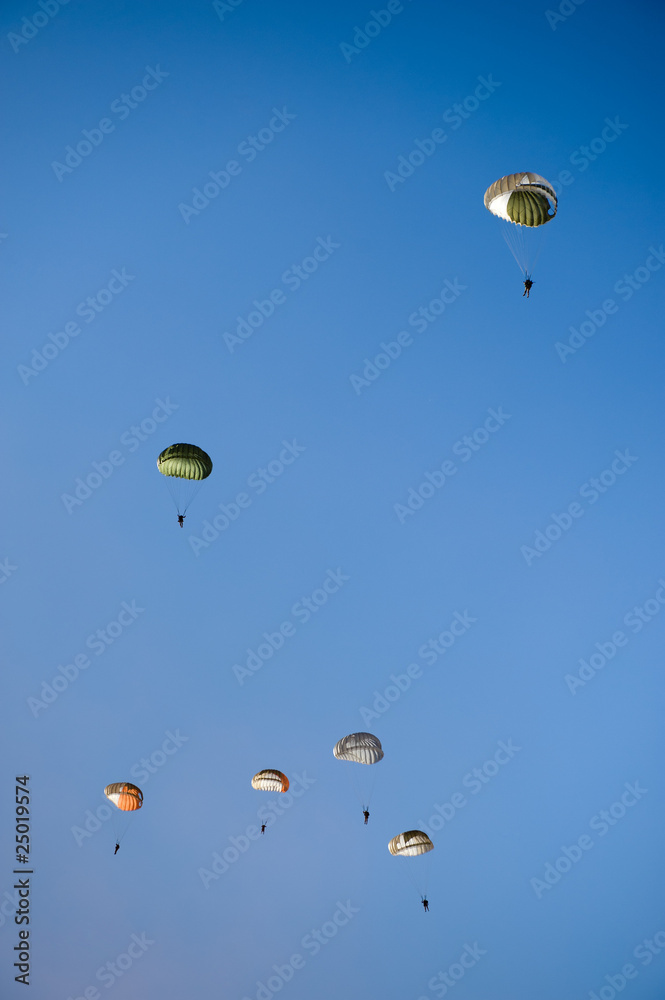 Paratroopers against blue sky
