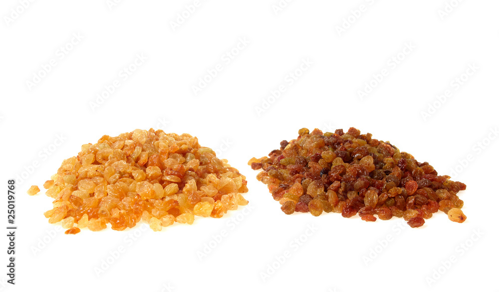 Two heaps of raisins isolated on white Two heaps of raisins isolated on white