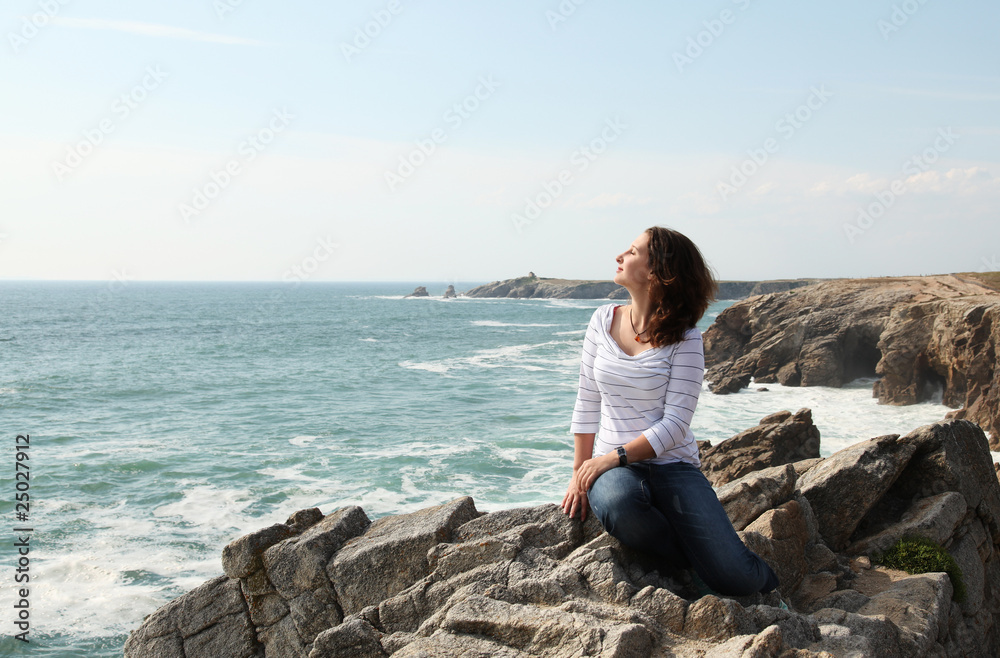Young girl enjoying wind and the ocean