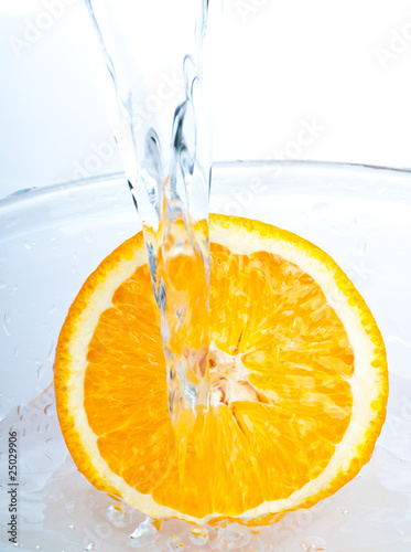 Fototapeta Naklejka Na Ścianę i Meble -  orange into water splash