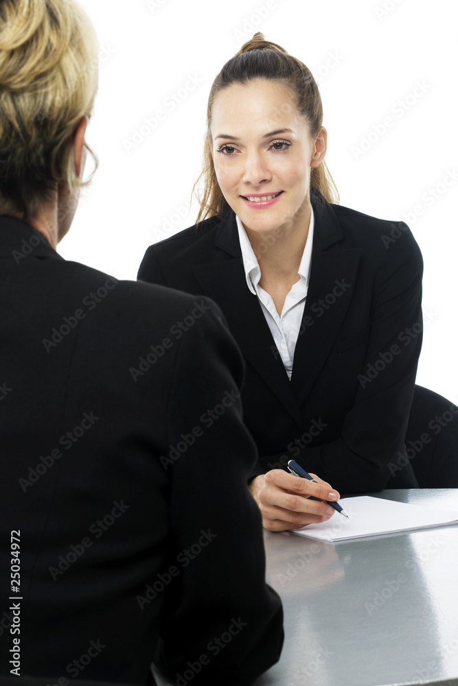 two women during a business meeting on white background studio two women during a business meeting on white background studio