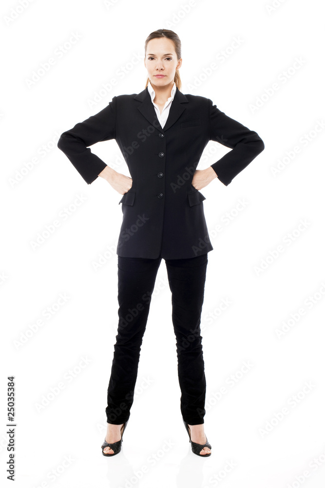 Young businesswoman standing with arms akimbo Young businesswoman standing with arms akimbo