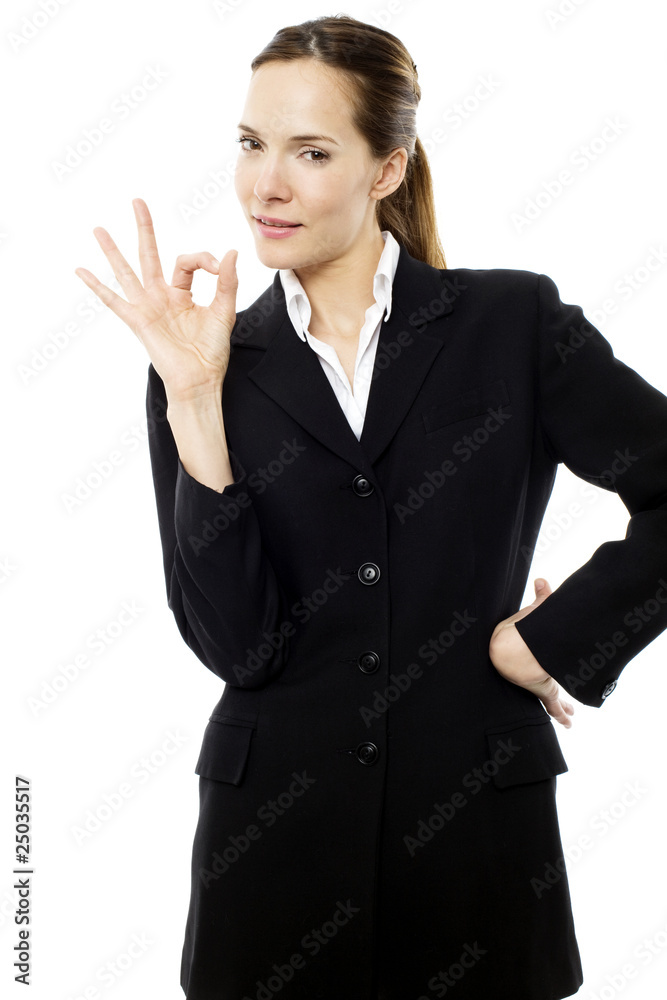 young businesswoman with her hand indicating ok young businesswoman with her hand indicating ok