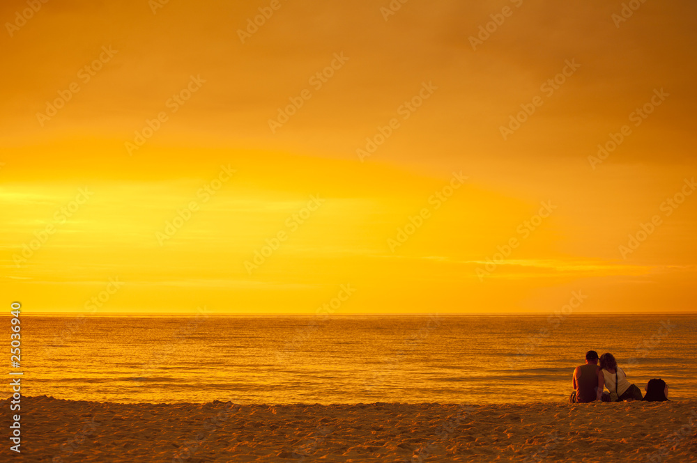 Zakochana para podziwiająca zachód słońca nad morzem