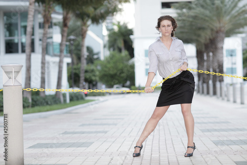 Image of a businesswoman tugging on a rope