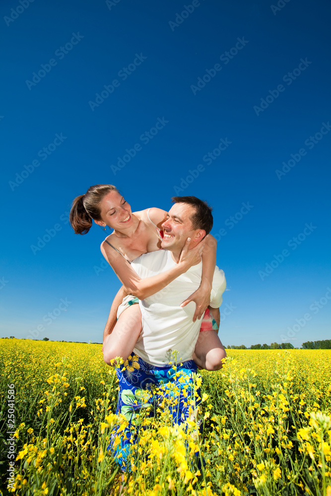 Young love Couple smiling under blue sky Young love Couple smiling under blue sky