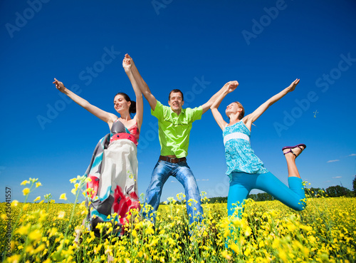 Happy people is jumping in field