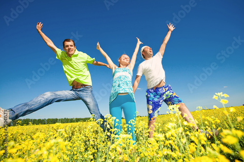 Happy people is jumping in field