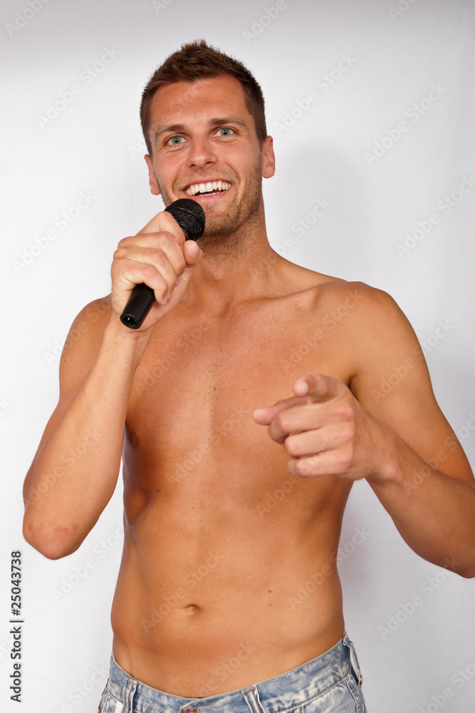 Fototapeta premium Karaoke with happy young man