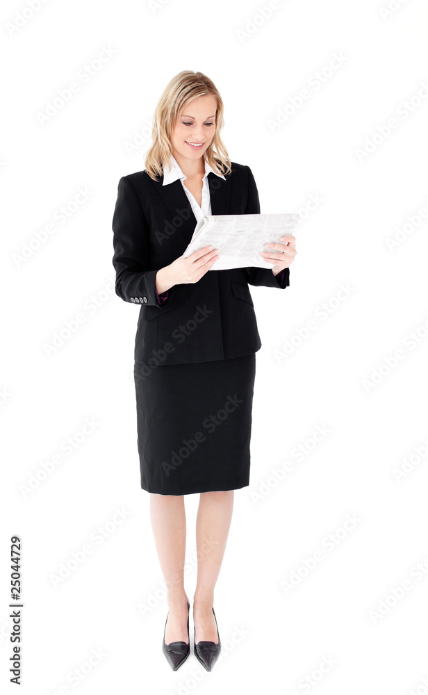 Self-assured businesswoman reading a newspaper Self-assured businesswoman reading a newspaper