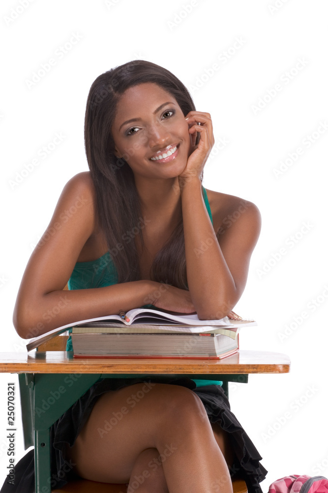 Black college student woman with book by desk Black college student woman with book by desk