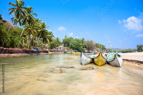 Beautiful view on small indian river with fishing boats