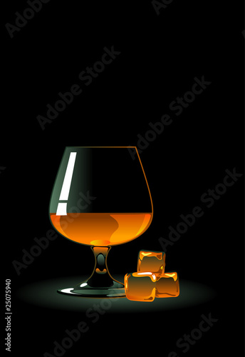 Glass of whiskey with ice on black.