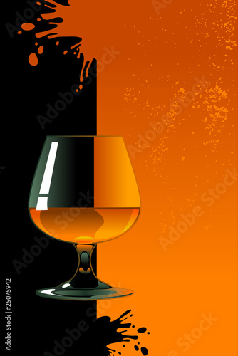 Glass of whiskey on orange and black background.