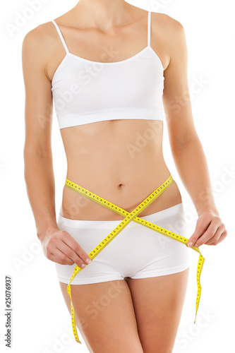 Woman measuring her slim body isolated on white