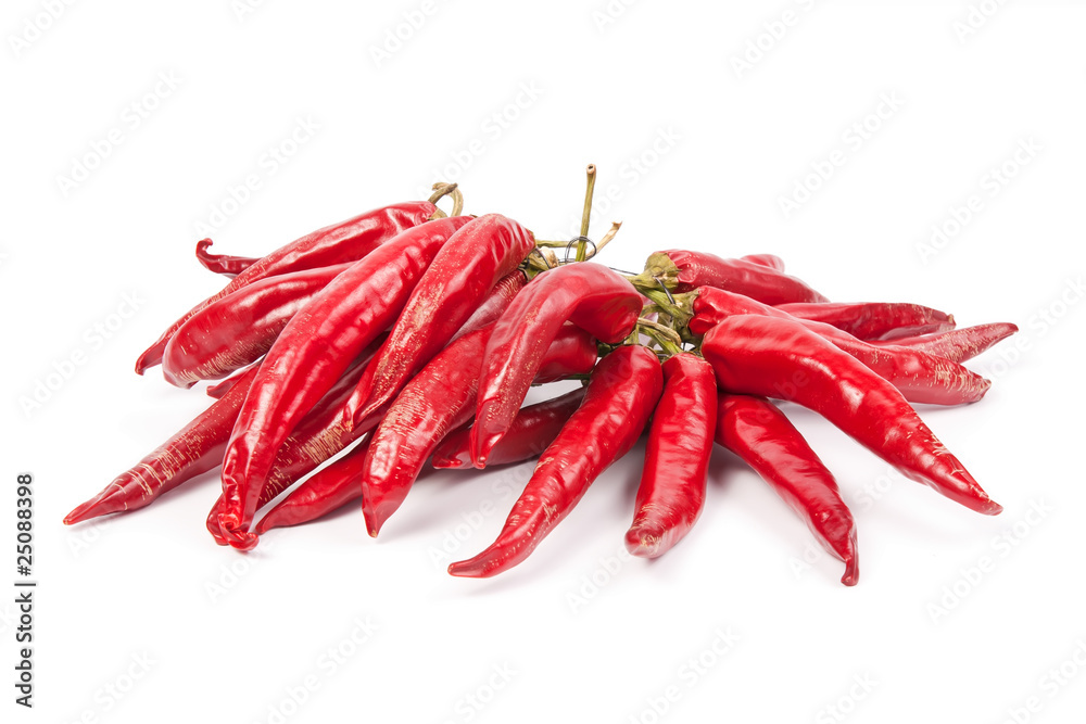 A string with a bunch of red chilli peppers isolated on white ba A string with a bunch of red chilli peppers isolated on white ba