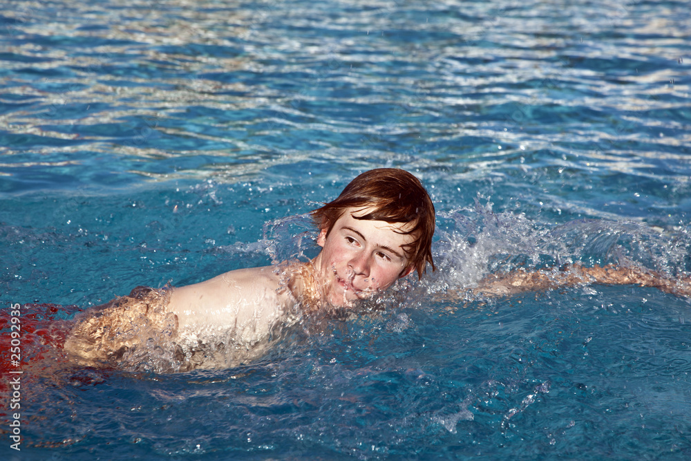 boy is crawling in the pool